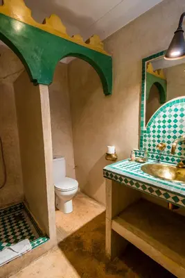a bathroom with a sink and a toilet in a room at Riad dar Ourika & SPA in Marrakech