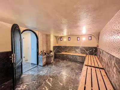 a room with a wooden bench and a wooden table at Riad Al Rimal & Spa in Marrakech