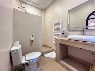 a bathroom with a white toilet and a sink at Riad Al Rimal & Spa in Marrakech