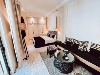 a living room with a bed and a couch at Riad Al Rimal & Spa in Marrakech