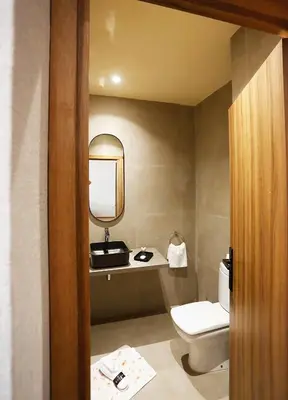 a bathroom with a toilet and a mirror at Rawabi Hotel Marrakech & Spa in Marrakech