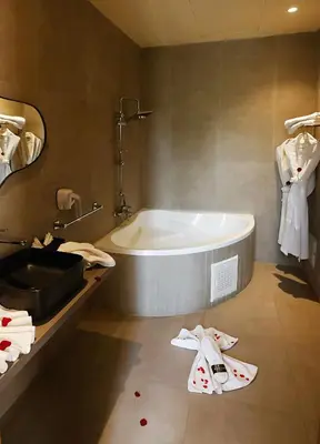 a bathroom with a bath tub and a sink at Rawabi Hotel Marrakech & Spa in Marrakech