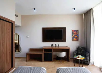 a living room with a desk and a tv at Rawabi Hotel Marrakech & Spa in Marrakech