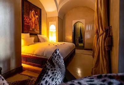a bedroom with a large bed in a room at Dar Les Cigognes in Marrakech