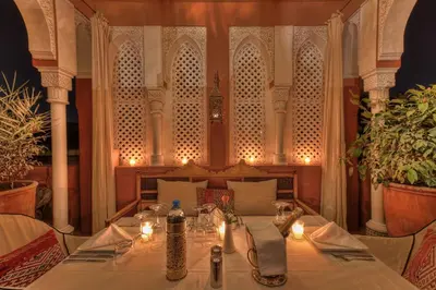 a table in a restaurant with candles on it at Riad Kaiss By Anika in Marrakech