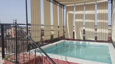 a balcony with a swimming pool on a building at Riad Eden in Marrakech