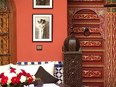 a room with a bed and a picture of a woman at Riad Eden in Marrakech