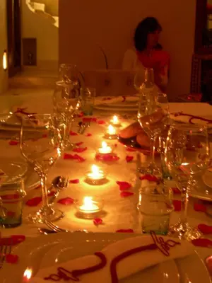 a table with candles and wine glasses on it at Riad la Cigale in Marrakech