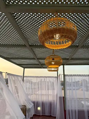 a room with white curtains and a chandelier at Riad la Cigale in Marrakech