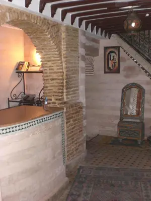 a room with a brick fireplace and a stove at Riad Hiba in Marrakech
