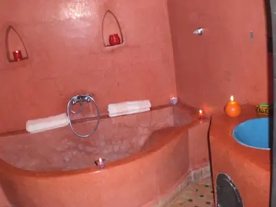 a bathroom with a tub and a sink at Riad Hiba in Marrakech