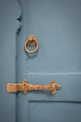 a blue door with a wooden handle on it at Riad Khalifa in Marrakech