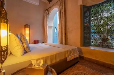 a bedroom with a bed and a window at Riad Khalifa in Marrakech