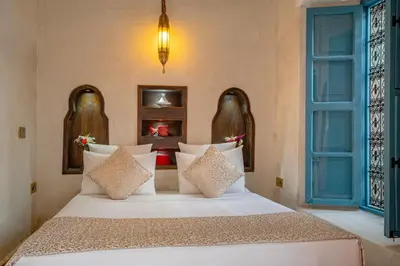 a bedroom with a large white bed with pillows at Riad Khalifa in Marrakech