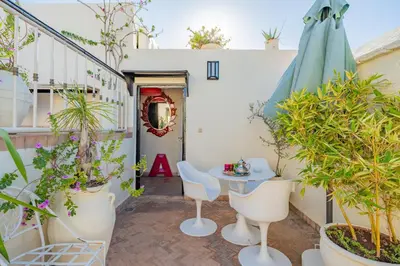 a patio with a table and chairs and plants at Maison Du Tresor in Marrakech