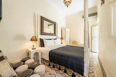 a hotel room with a bed and a mirror at Maison Du Tresor in Marrakech
