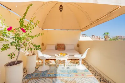 a patio with a table and chairs and a tent at Maison Du Tresor in Marrakech