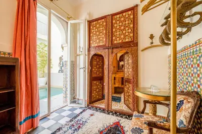 a room with a large wooden door and a table at Maison Du Tresor in Marrakech