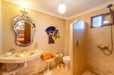 a bathroom with a sink and a mirror and a toilet at Maison Du Tresor in Marrakech