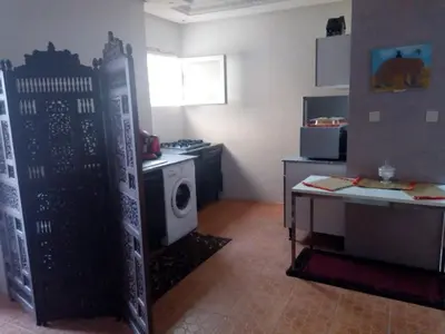 a kitchen with a stove and a washing machine at Marrakech autrement in Marrakech