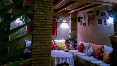 a living room with a couch with pillows on it at Riad Gallery 49 & Spa in Marrakech