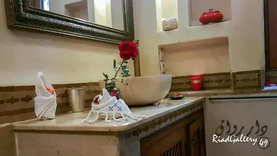 a bathroom counter with a sink and a mirror at Riad Gallery 49 & Spa in Marrakech