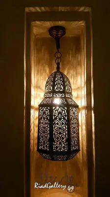 a black lantern hanging from a wall in a room at Riad Gallery 49 & Spa in Marrakech