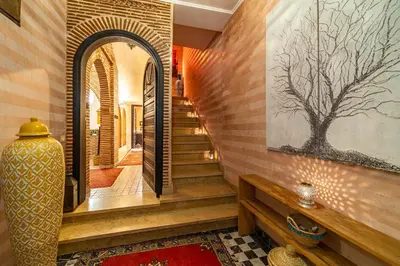 a hallway with stairs and a painting on the wall at Riad Appart Arwa in Marrakech