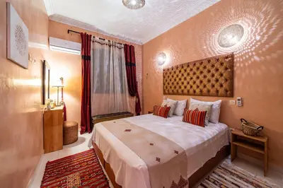 a bedroom with a large bed in a room at Riad Appart Arwa in Marrakech