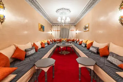 a large room with a long couch and a red carpet at Riad Appart Arwa in Marrakech