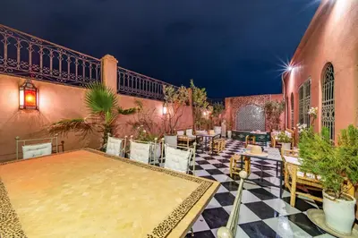 a patio with tables and chairs on a building at Riad Appart Arwa in Marrakech