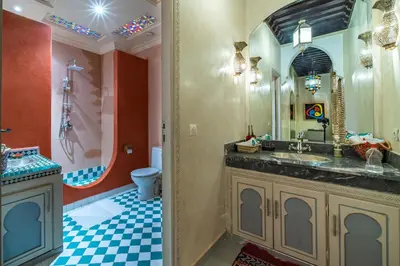 a bathroom with a sink and a mirror at Riad Appart Arwa in Marrakech