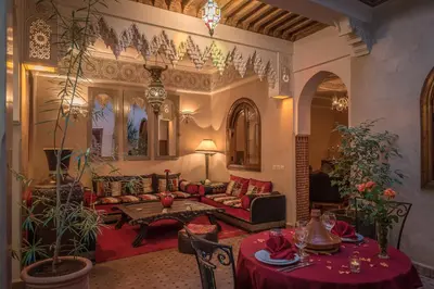 a living room with a couch and a table at Riad Dar Attika in Marrakech