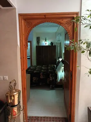 an archway into a bedroom with a bed at Riad Dar Attika in Marrakech