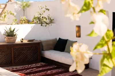 a couch in a room with plants on the wall at Maison Manzano in Marrakech