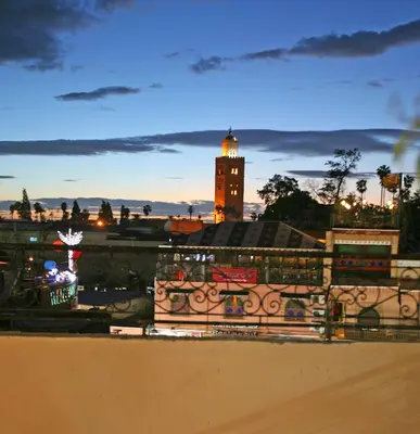 a building with a clock tower in the distance at Riad Taghazoute in Marrakech