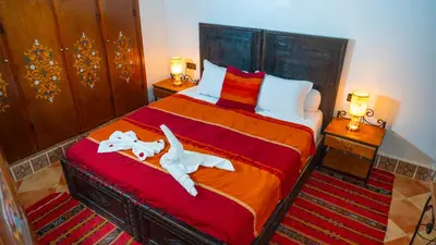 a bedroom with a bed with two towels on it at Riad Taghazoute in Marrakech