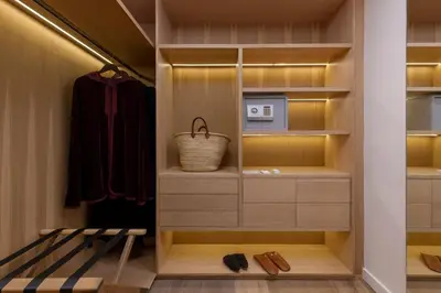 a walk in closet with wooden cabinets and a microwave at Ksar Char-Bagh Small Luxury Hotels in Marrakech