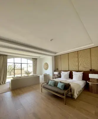 a large bedroom with a large bed and a couch at Ksar Char-Bagh Small Luxury Hotels in Marrakech