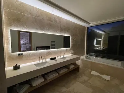 a bathroom with two sinks and a large mirror at Ksar Char-Bagh Small Luxury Hotels in Marrakech