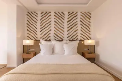 a bedroom with a large bed with two night stands at Ksar Char-Bagh Small Luxury Hotels in Marrakech
