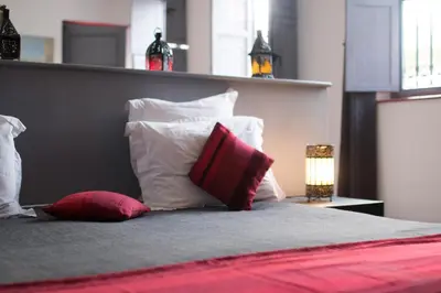 a bedroom with a bed with pillows at Riad Alegria in Marrakech