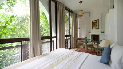 a bedroom with a bed and a large window at Riad Lyla in Marrakech