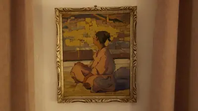 a painting of a woman on a wall at Riad Lyla in Marrakech