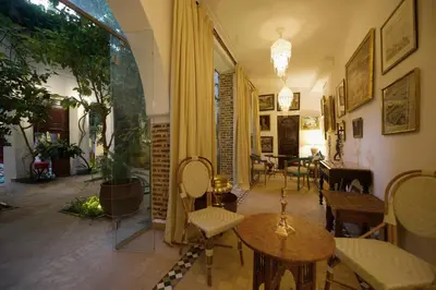a hallway with a table and chairs and a dining room at Riad Lyla in Marrakech