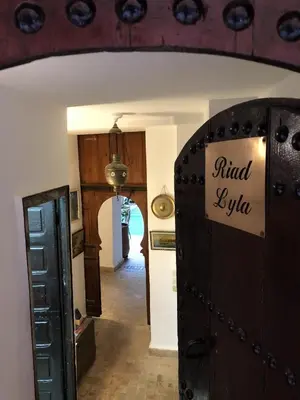 a room with a hallway with a find extra sign on a door at Riad Lyla in Marrakech