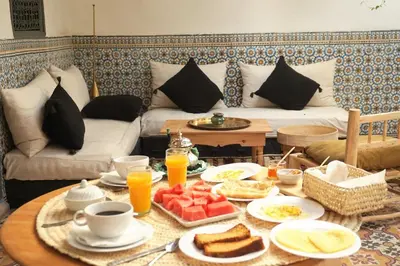 a breakfast table with breakfast foods and orange juice at Riad Chamali in Marrakech