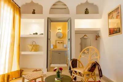 a room with chairs and a table and a mirror at Riad Chamali in Marrakech