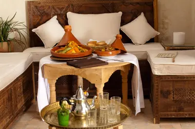 a table with a plate of food on top of it at Riad Shambala in Marrakech
