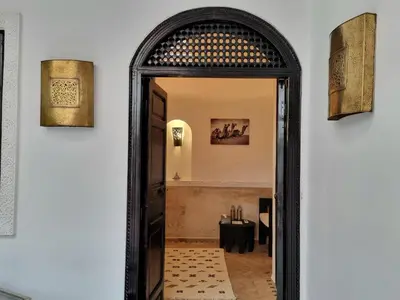 an archway leading into a room with a table in a room at Riad les Rêves d'Amélie in Marrakech